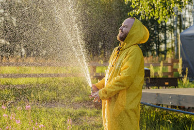 Man standing on grass during rainy season