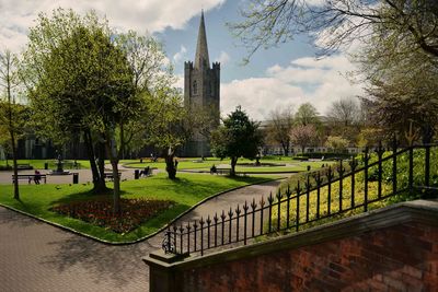 View of cemetery and trees against sky