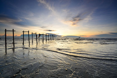 Scenic view of beach against sky during sunset