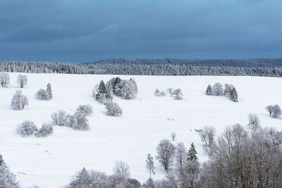 Scenic view of snow covered field against sky