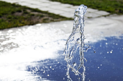 Fountain with a water jet and bokeh background 2019-06-15 dragon, umea, sweden