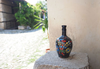 Close-up of vase against wall