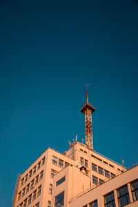 Low angle view of building against clear blue sky