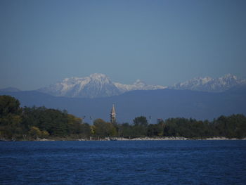 Scenic view of sea and mountains against clear sky