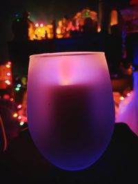 Close-up of lit candle on table