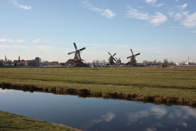 Traditional windmill on field against sky