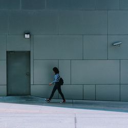 Full length of woman standing by railing