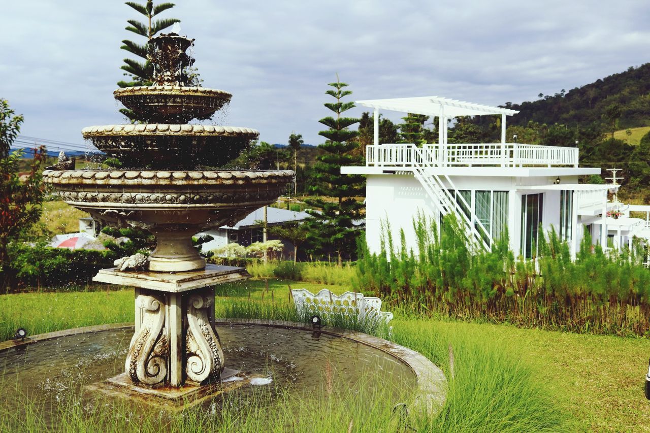 water, plant, grass, architecture, built structure, nature, cloud - sky, sky, day, no people, fountain, park, formal garden, park - man made space, garden, growth, outdoors, tree, building exterior, spraying