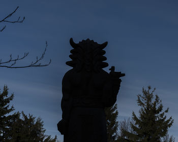 Low angle view of silhouette statue against sky at dusk