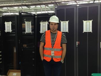 Portrait of man in reflective clothing standing at factory