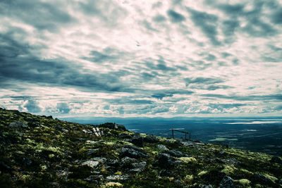 Scenic view of calm sea against cloudy sky