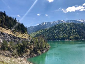 Scenic view of lake and mountains against sky