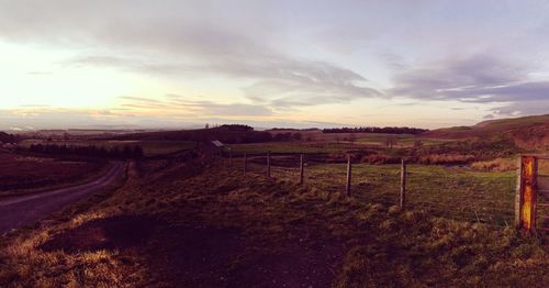 Scenic view of field against sky during sunset