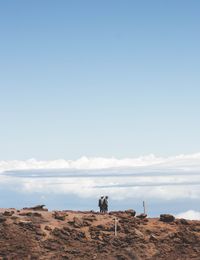 People standing on desert against sky