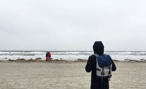 Rear view of two people on beach