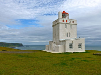 Lighthouse against cloudy sky