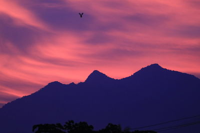Silhouette of mountain range against sunset sky