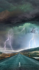 Panoramic view of lightning over road