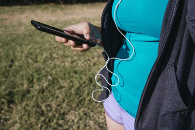 Midsection of woman using mobile phone