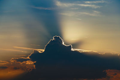 Silhouette person against sky during sunset