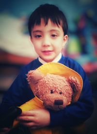 Portrait of smiling boy playing with toy