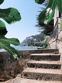 Staircase by mountain against sky