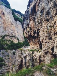 Low angle view of rock formation on land against sky