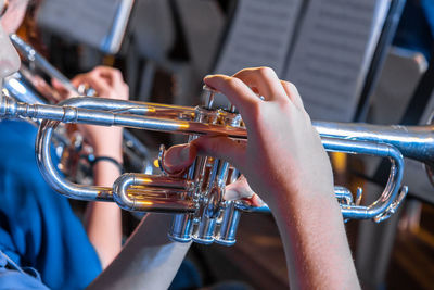 Cropped hands of people playing musical instrument