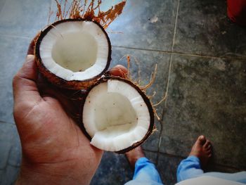 Low section of man holding coconut 