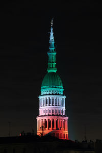 Illuminated building against sky at night