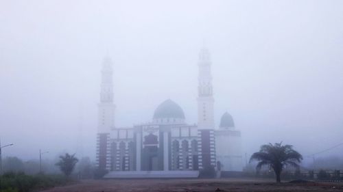 View of cathedral against sky during foggy weather