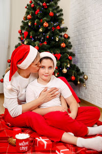 Family spending time near christmas tree. mother with son