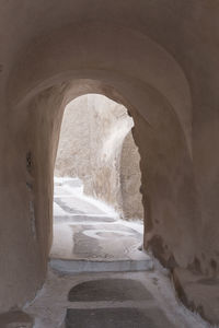 Archway amidst sea seen through tunnel