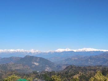 Scenic view of mountains against clear blue sky