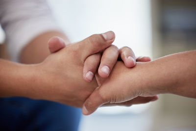 Cropped image of couple holding hands