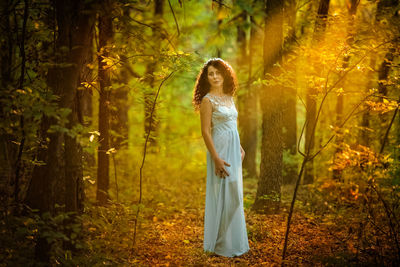 Woman standing in forest