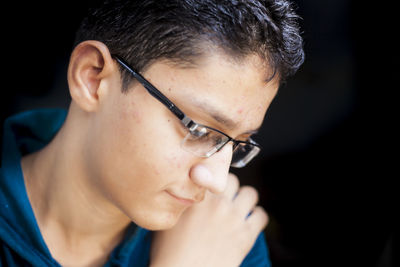 Close-up of boy in eyeglasses at home