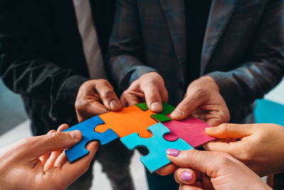 Midsection of man playing jigsaw puzzle