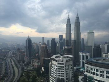 Cityscape against cloudy sky