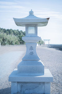 Close-up of stone railing against sky