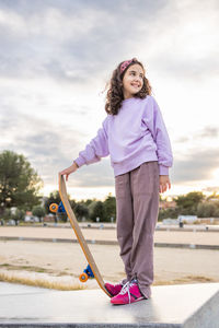 Little girl having fun with a skate board