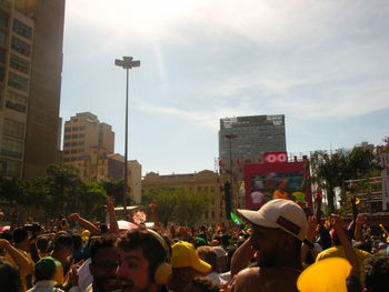 People on street in city against sky