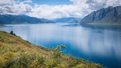 Scenic view of lake and mountains against sky