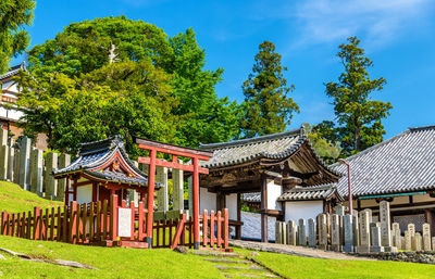 Traditional building with trees against blue sky