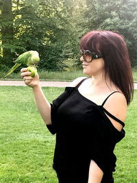 Young woman wearing sunglasses while standing on land