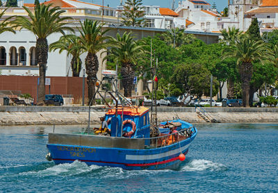 Boat in sea against building