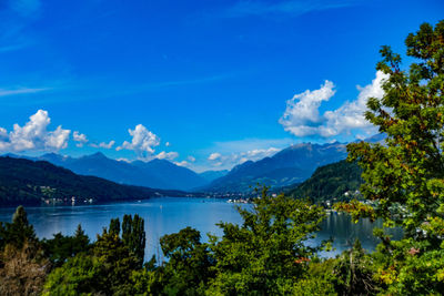 Scenic view of lake and mountains against blue sky