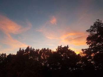 Low angle view of silhouette trees against sky at sunset