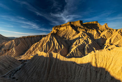 Scenic view of mountain range against cloudy sky