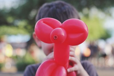 Close-up of hand holding red balloons